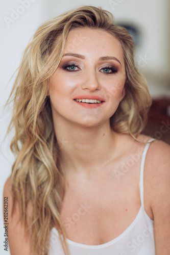 Portrait of beautiful young woman with makeup in fashion clothes