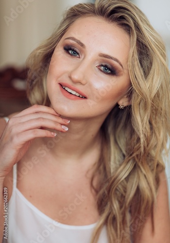 Portrait of beautiful young woman with makeup in fashion clothes