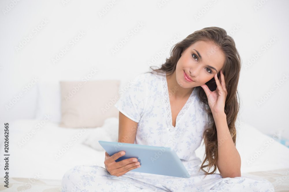 Peaceful attractive brunette using a tablet Peaceful attractive brunette using a tablet