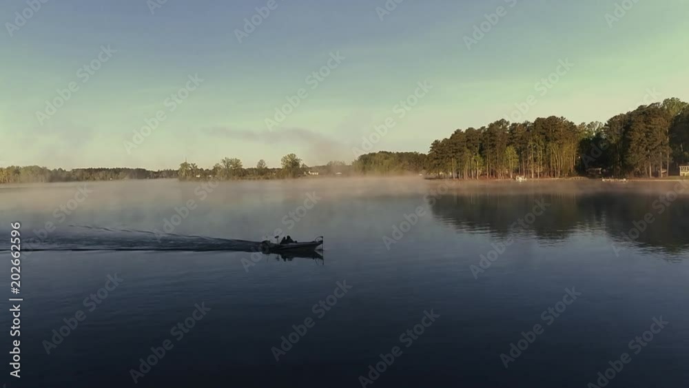 Fisherman on Lake Greenwood during early spring morning fog. Fisherman on Lake Greenwood during early spring morning fog.