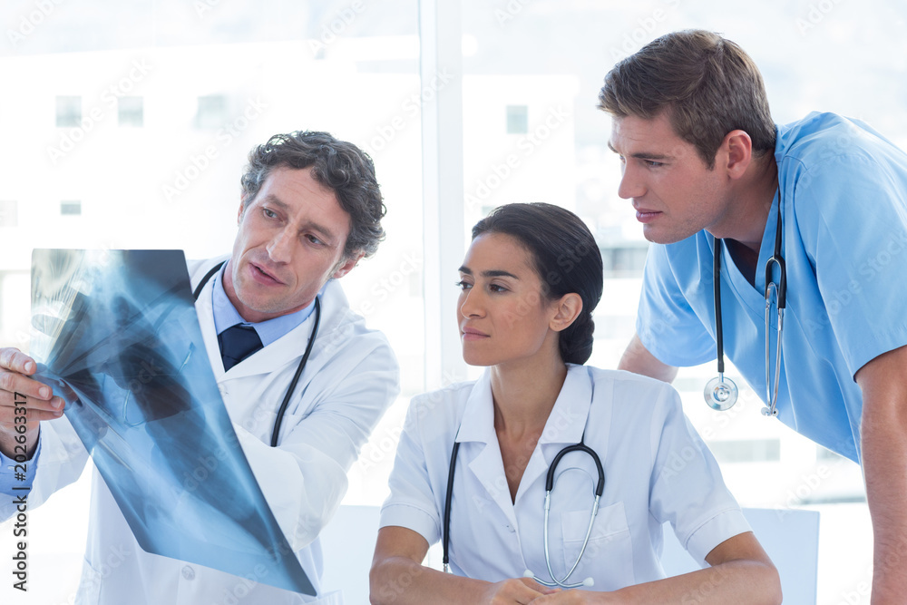 Team of doctors analyzing xray