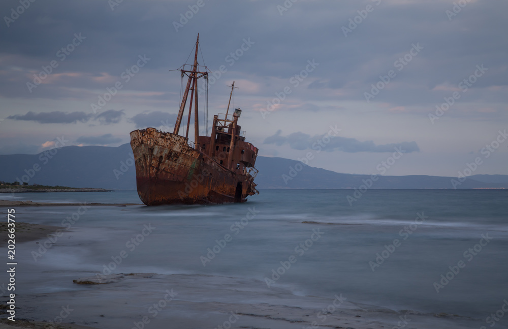 The famous rusty shipwreck near Gytheio at sunset The famous rusty shipwreck near Gytheio at sunset