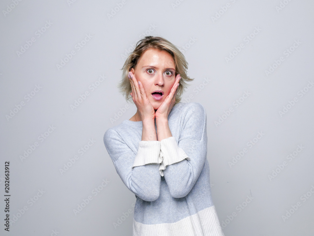 Adult shocked woman hold her face in hands. Adult shocked woman hold her face in hands.