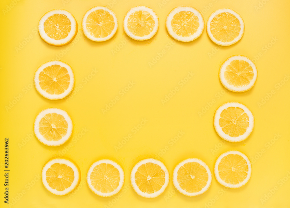 Fresh lemon slices on yellow background. Top view. Place for text. Fresh lemon slices on yellow background. Top view. Place for text.