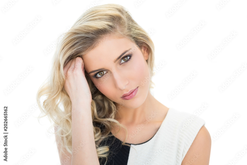 Thoughtful smiling blonde model looking at camera Thoughtful smiling blonde model looking at camera