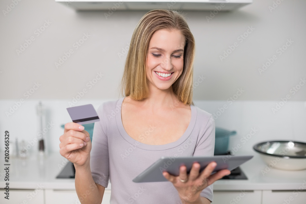 Happy gorgeous model holding tablet and credit card Happy gorgeous model holding tablet and credit card