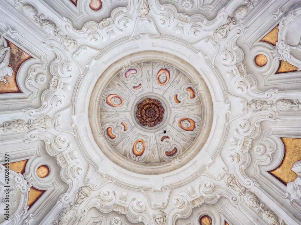 White stucco ceiling sculpted inside a votive chapel.