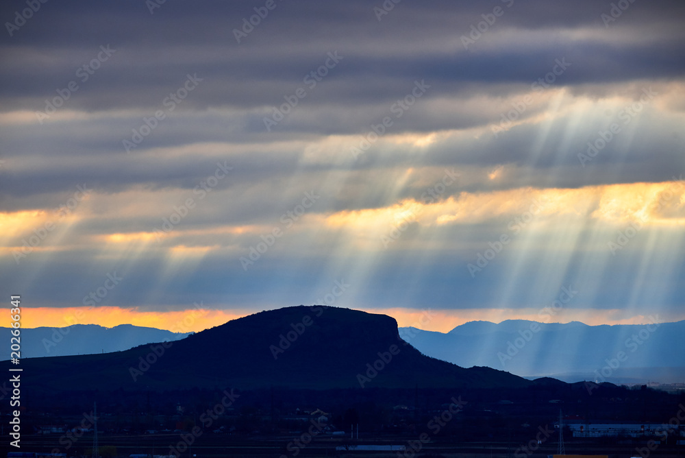 Sun rays above hill