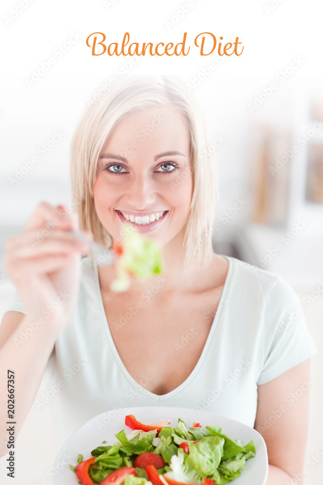 The word balanced diet against charming woman offering salad The word balanced diet against charming woman offering salad