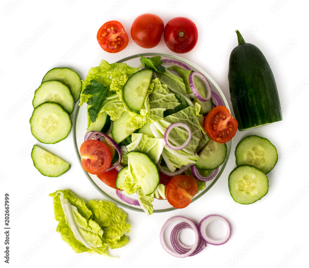 Vegetable salad in plate and ingredients with which it is made. The view from the top. Vegetable salad in plate and ingredients with which it is made. The view from the top.
