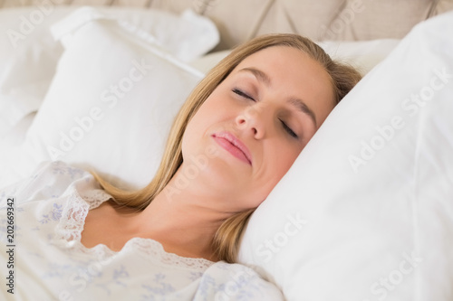 Natural content woman slumbering in bed