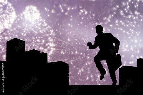 Businessman with briefcase against white fireworks exploding on black background