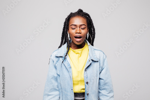 Young afro american woman screaming isolated on gray background photo