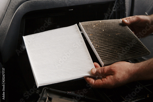 replacing cabin air conditioner filter of car photo