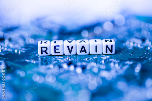 Word REVAIN formed by alphabet blocks on mother cryptocurrency photo