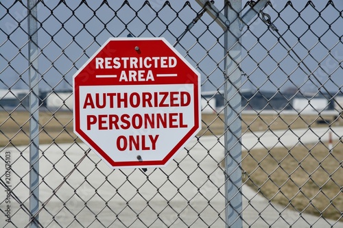 Restricted Area Authorized Personnel Only Sign on a Fence