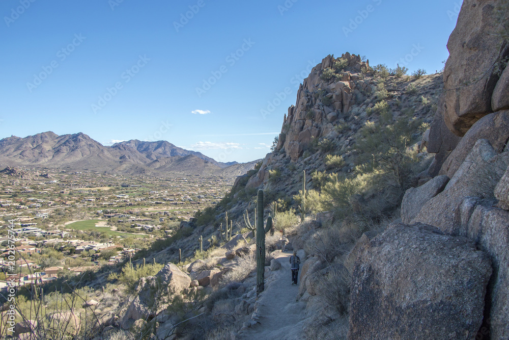 Hiker going down Pinnacle Peak trail in North Scottsdale, AZ