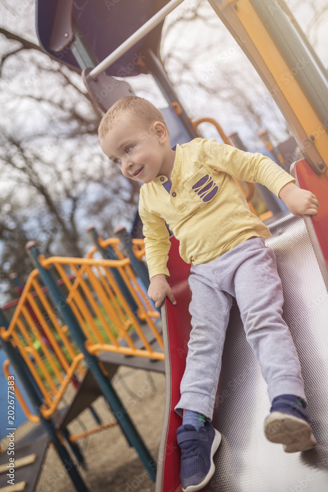 Adorable little boy having fun on playground Adorable little boy having fun on playground