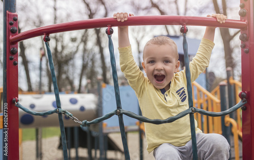 Adorable little boy having fun on playground