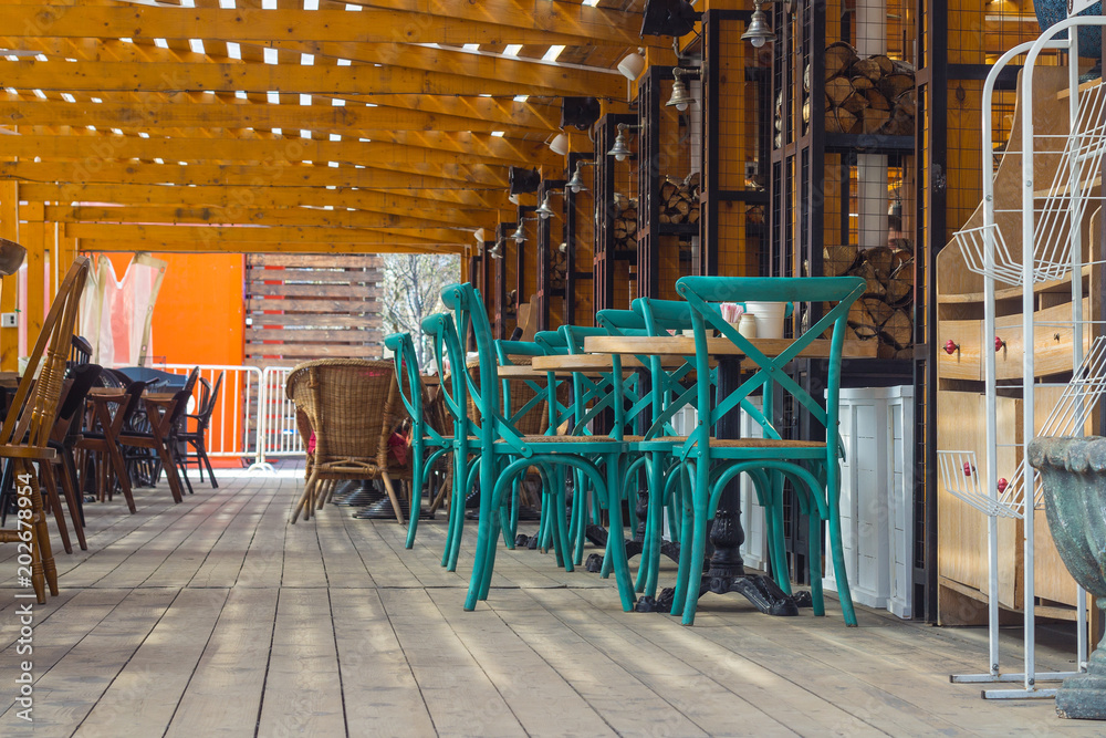 Fototapeta premium Green chairs in an empty summer cafe