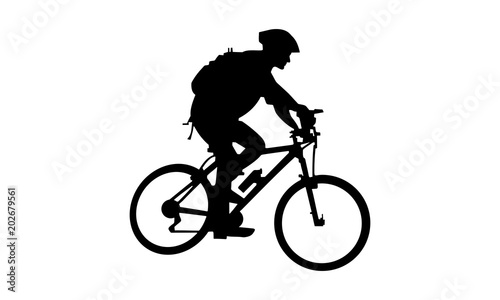 the silhouette of a man riding a mountain bike with a backpack