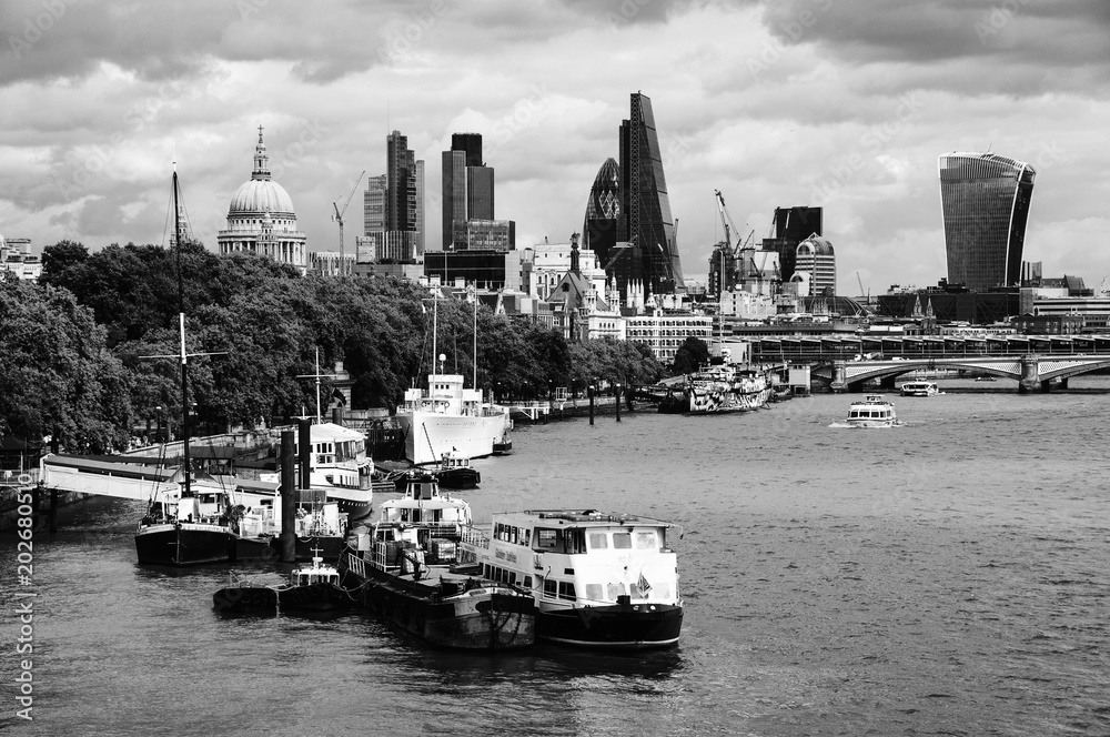 Cityscape with St Paul Cathedral and modern buildings of London City, UK. Black and white