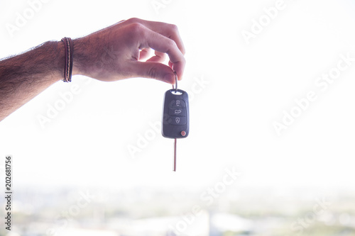 business man hand with a car key. Isolated on white background