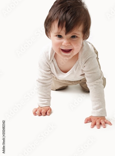 the baby learns to crawl isolated on white background