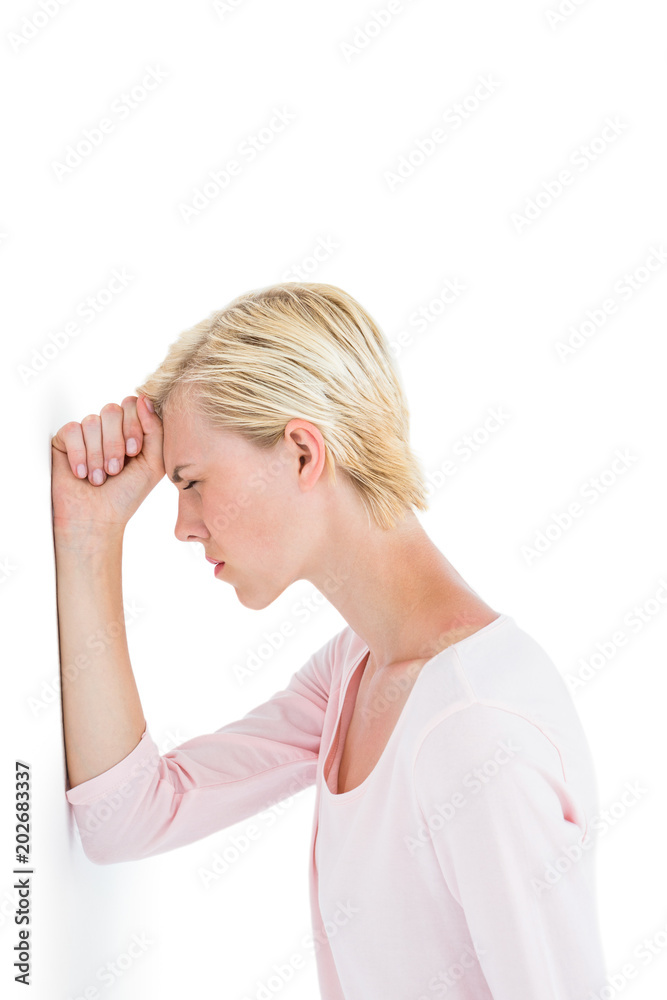 Nervous blonde woman leaning against the wall Nervous blonde woman leaning against the wall