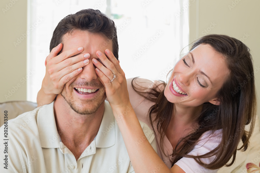 Close-up of a woman covering mans eyes Close-up of a woman covering mans eyes