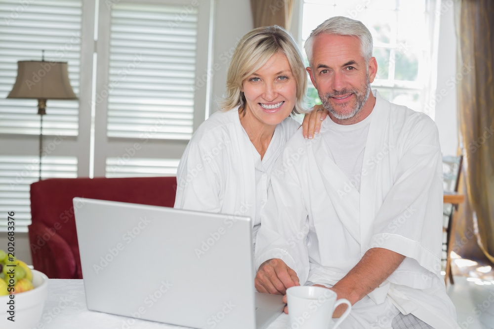 Relaxed mature couple with laptop at home Relaxed mature couple with laptop at home