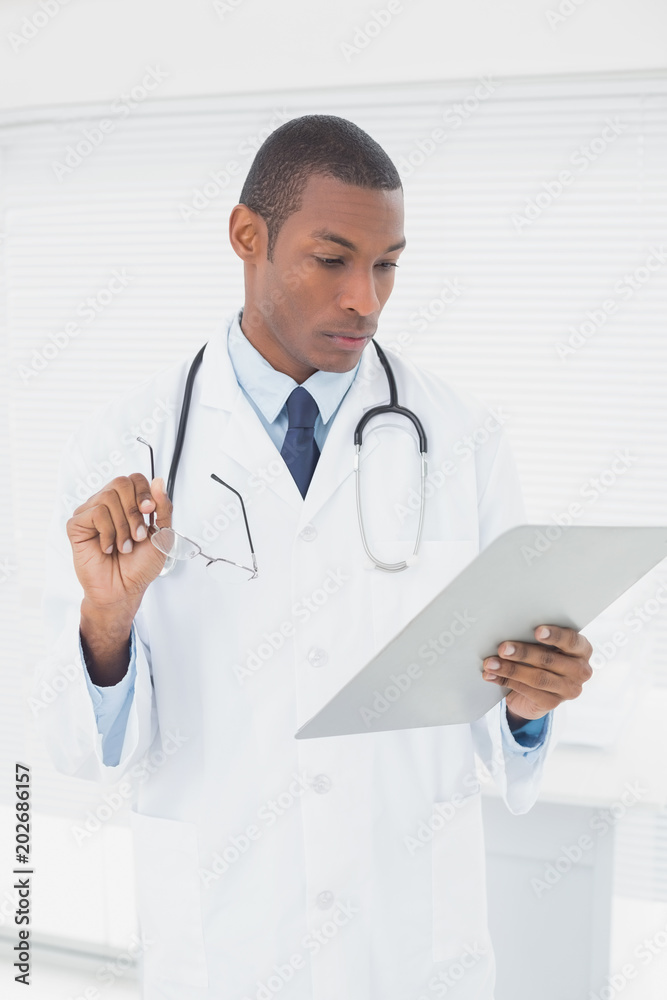 Serious male doctor writing a prescription Serious male doctor writing a prescription