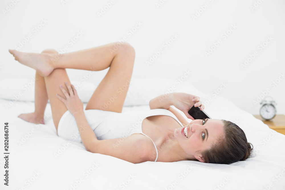 Portrait of a woman using mobile phone in bed Portrait of a woman using mobile phone in bed