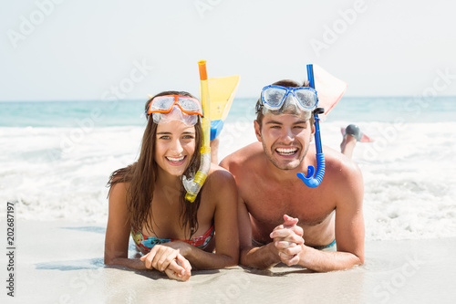 happy couple smiling at camera with mask and snorkel 