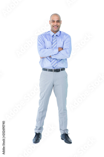 Happy businessman looking at camera with arms crossed  © WavebreakmediaMicro