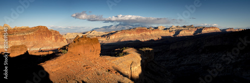viewpoint of capitol reef national park in utah in the spring time with clear blue skies  rock outcrops  canyons  narrows and juniper trees