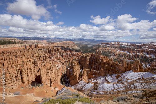 viewpoint of bryce canyon in utah in the spring time with snow on the ground and clear blue skies