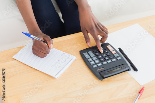 Close up of a woman using a calculator