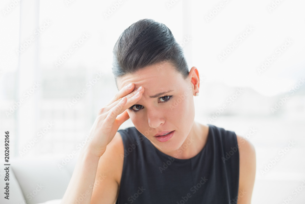 Close up portrait of a businesswoman suffering from headache Close up portrait of a businesswoman suffering from headache