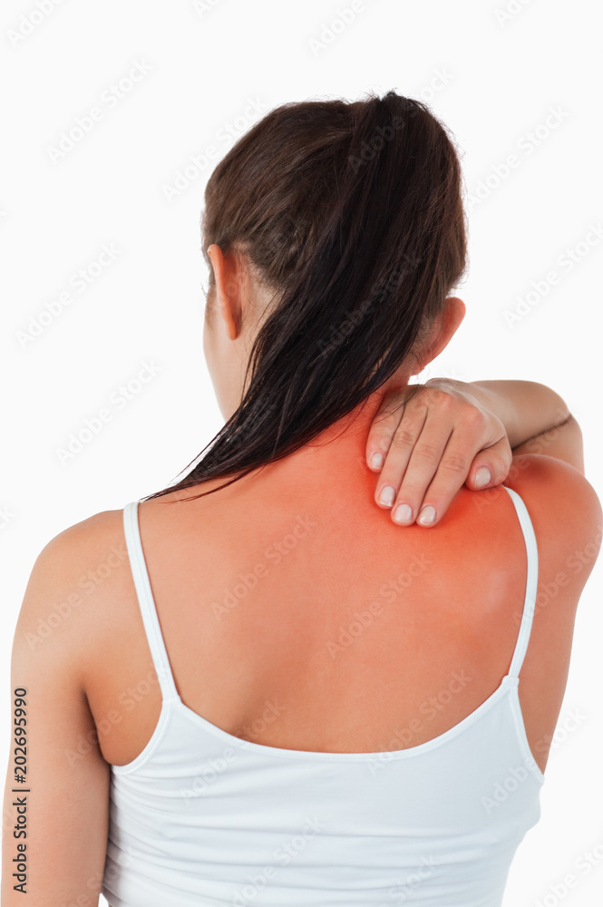 Back view of female with pain in her neck against a white background Back view of female with pain in her neck against a white background