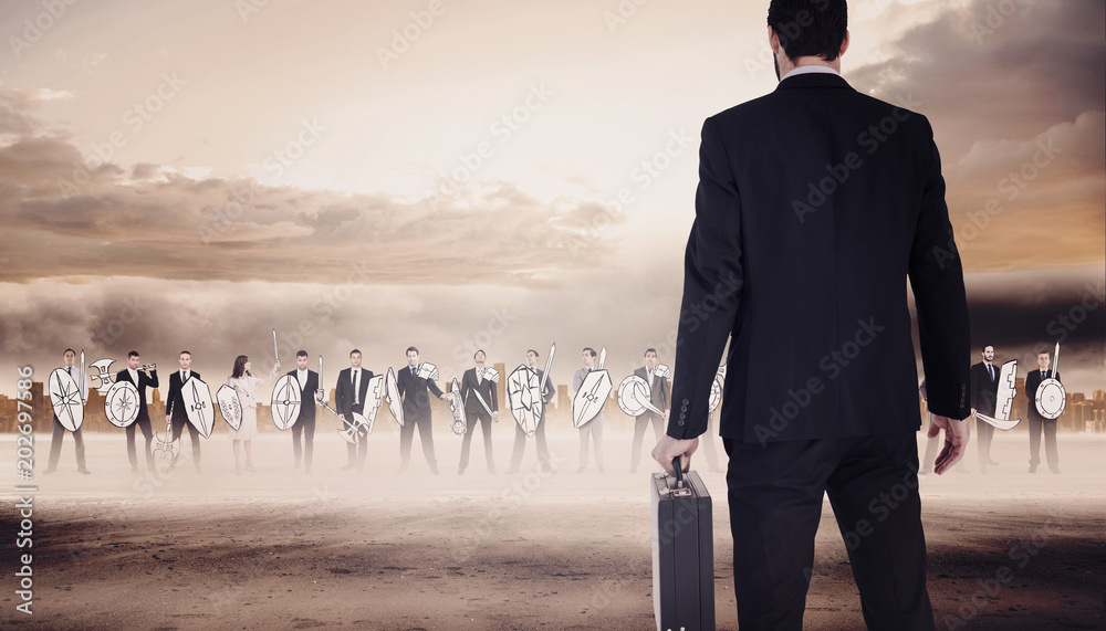 Φωτογραφία Rear view of businessman holding a briefcase against large city on the horizon