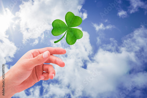Shamrock against bright blue sky with clouds © vectorfusionart