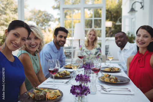 Happy friends having lunch together in restaurant