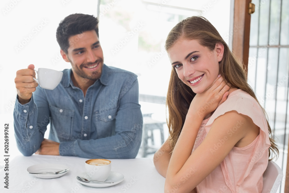 Fototapeta premium Portrait of a smiling couple at coffee shop