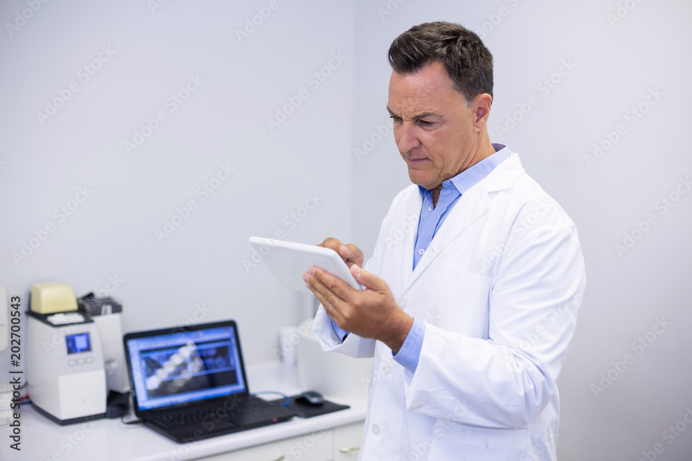Attentive dentist using digital tablet Attentive dentist using digital tablet