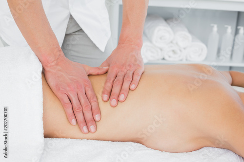 Closeup of a physiotherapist massaging womans back