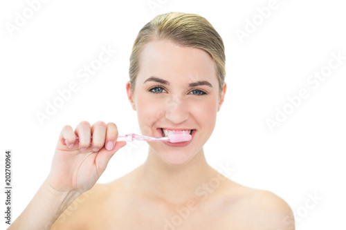 Attractive blonde brushing her teeth