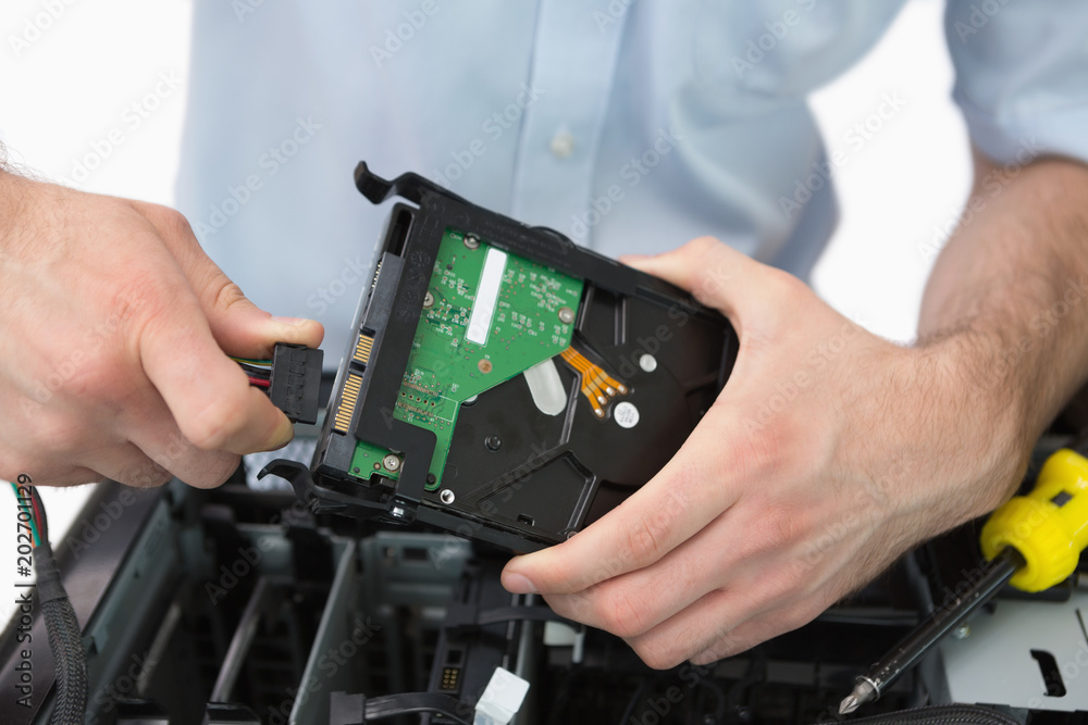 Hands fixing cable to hard disk Hands fixing cable to hard disk