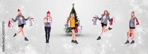 Stylish blonde holding shopping bags against white snowflake design on grey