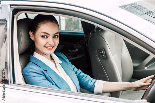 Businesswoman driving her car with smiling and looking at camera on the way to office © Art_Photo